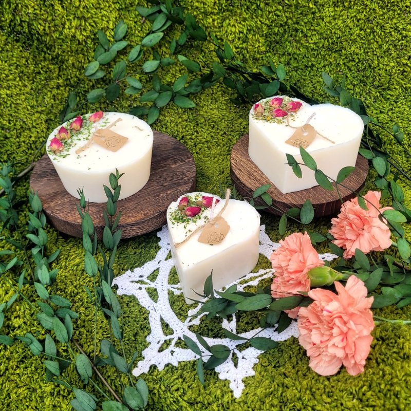 Handcrafted heart-shaped scented candle made with natural soy wax and decorated with real dried rose buds